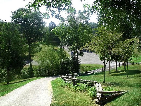 S.W. Paved Entry with Gate/split rail fence