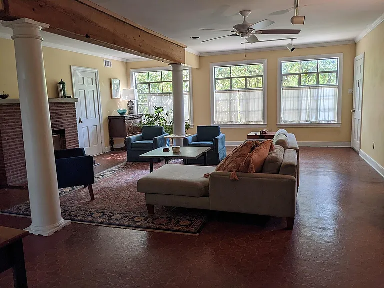 Downstairs Great Room - 20ft x 28ft _ with Wood Burning Fireplace & White Wooden Columns.