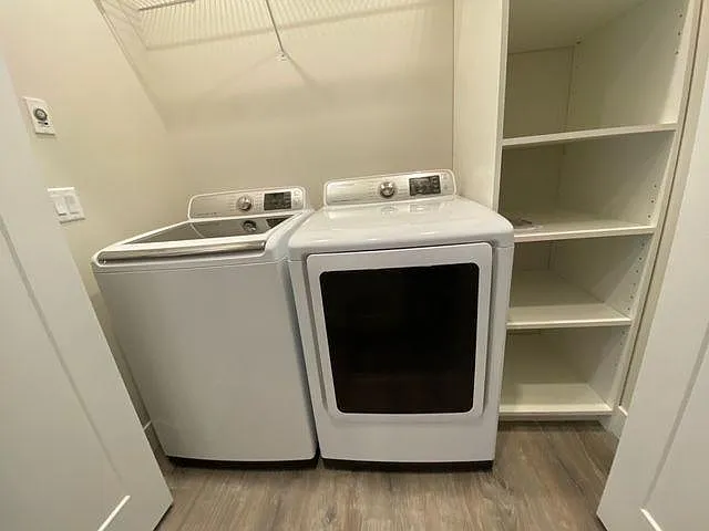 Full size Samsung washer and Gas dryer. Laundry area with storage.