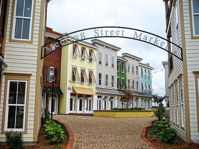 2088 is located in the courtyard behind the movie theatre in Ayrsley. The building exterior is light grey/white. (under the word street in photo)