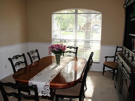 Formal dining room with wainscoting and chair railing