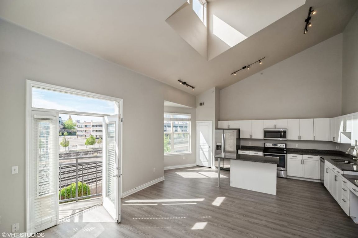 Kitchen features a beautiful view of the living space and the natural beauty outside