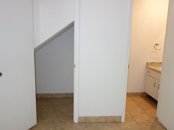 Under the stairs storage closet on left. Half Bath on right.