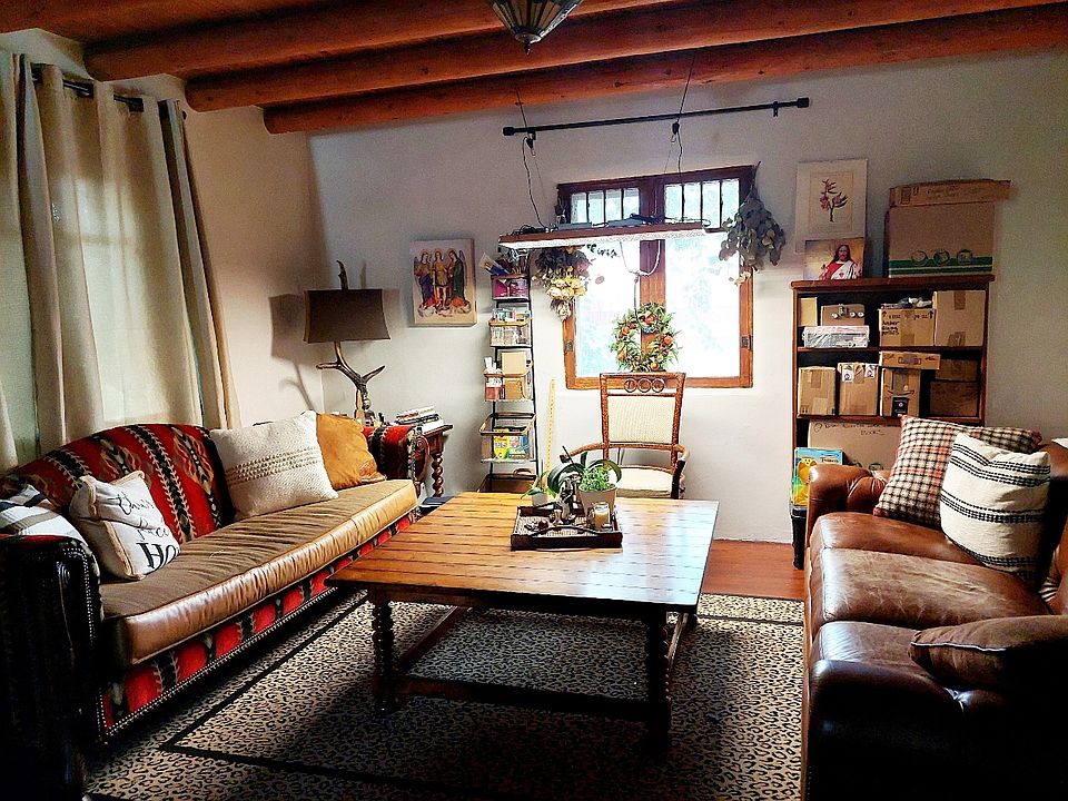 The Livingroom combo is separated by a sunken Fireplace. This home has both recent window but kept the original wood frame window for character. Has all wooden flooring.