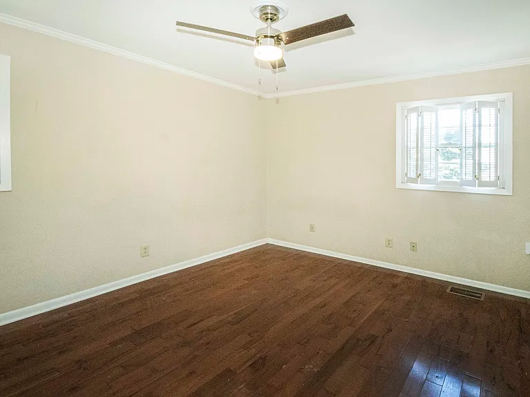 Primary suite has so much natural light plus great wall space for furnishings