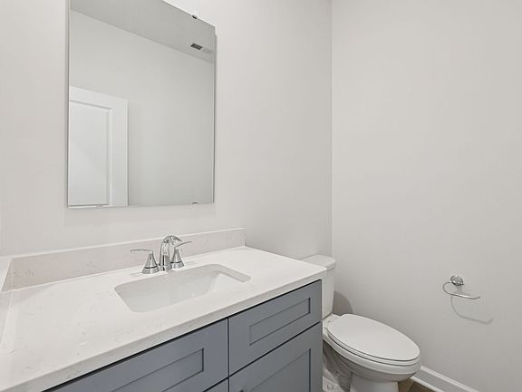 The half bathroom includes a storage vanity for a cleaner look to store your essentials.