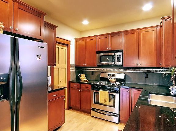 This Kitchen Is Gorgeous.Stainless Steel Appliances, Slab Granite & Gas Stove