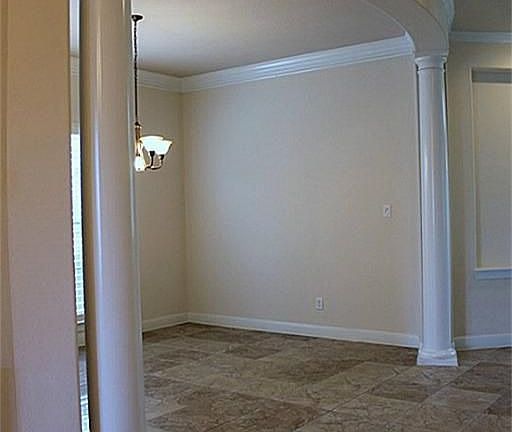 A peek into the spacious Formal Dining Room. Tile flooring, curved entry & plenty of room for your l