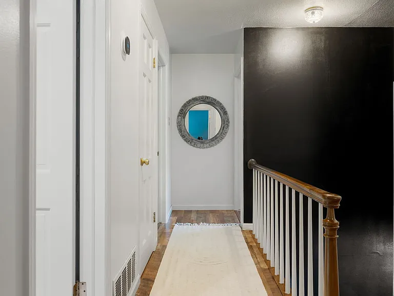Standing in second bedroom, which shares a wall with primary bedroom The upstairs hallway leads to full bath and two other bedrooms. The first door on left is a full bath, and two bedrooms are at the end of the hallway.