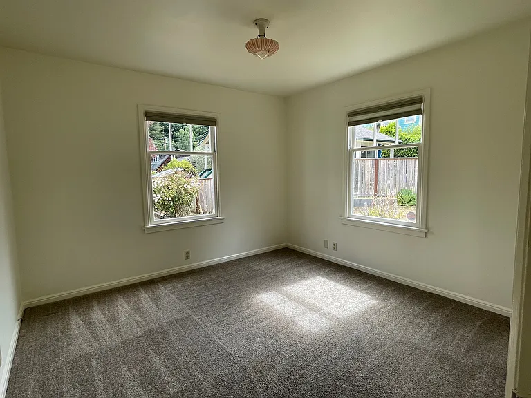 2nd bedroom with closet and garden view.