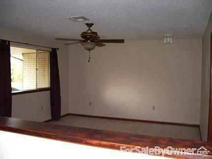 Living Room : Ceiling fan, Big window facing front yard with new carpet, new light in corner.