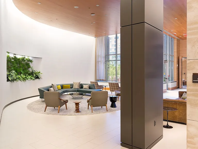 Open concept resident lounge featuring floor to ceiling windows