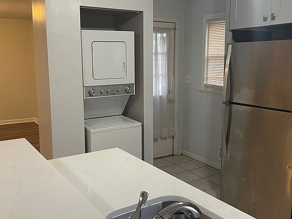 Another kitchen picture with view of washer/dryer and backdoor going out to back deck.
