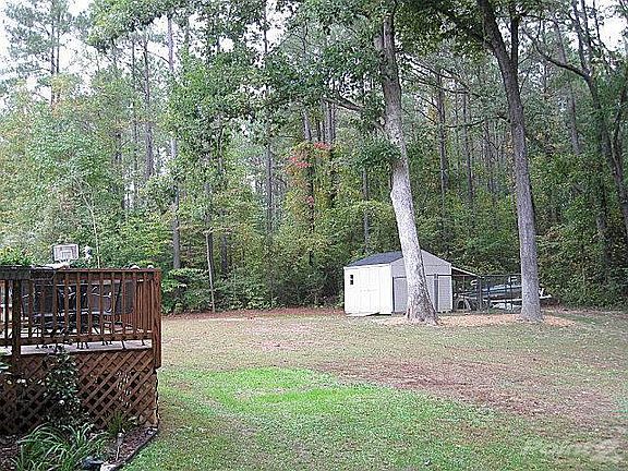 Beautiful home on double lot across street from lake! Shed stays, but not dog pen.