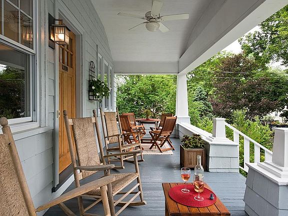Spacious front porch with rockers and ceiling fan