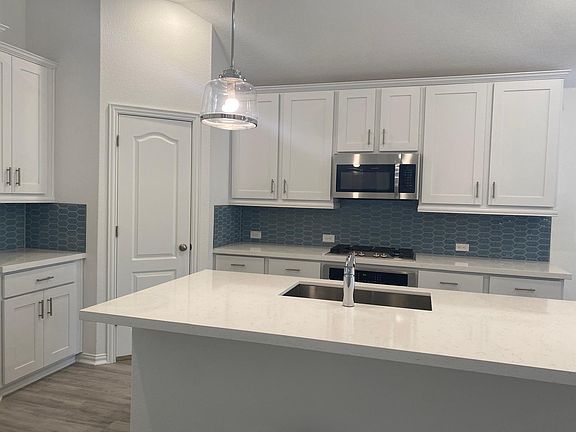 White kitchen with white quartz kitchen island