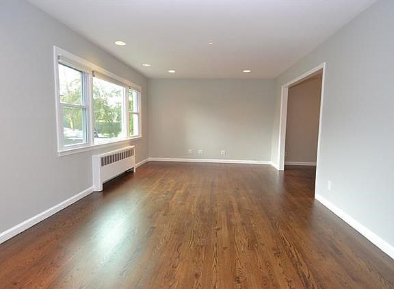 Spacious living room with beautiful hardwood floors.