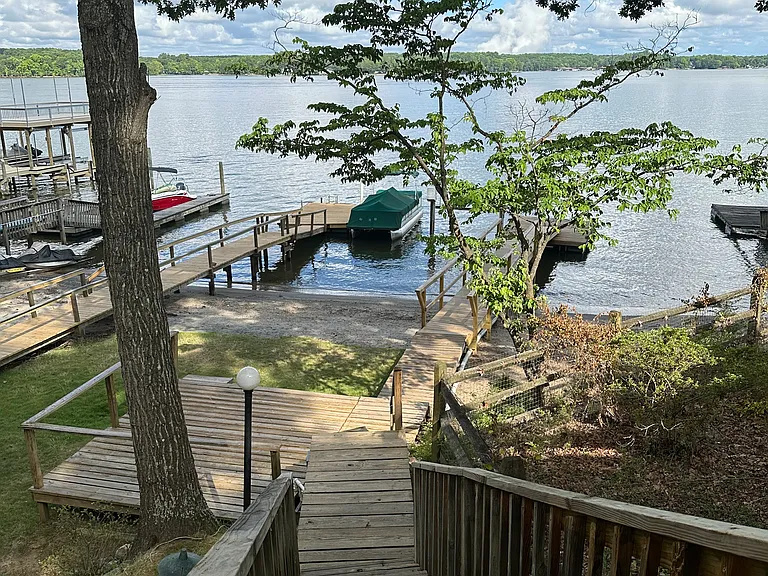 Back, steps to lower deck, dock and beach
