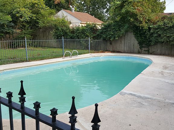 Iron gate surrounds pool.