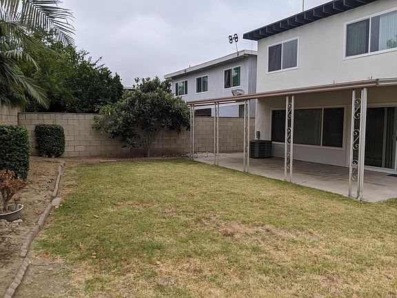 Fenced backyard with aluminum patio cover