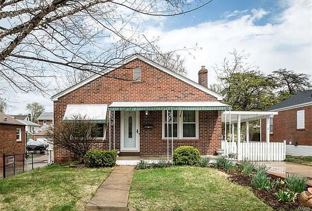 Welcome to this all brick bungalow with pretty landscaping and a covered porch.
