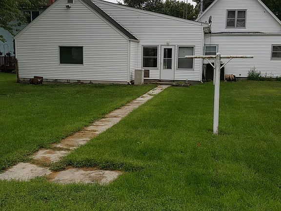 Backyard. Has clothes line poles.