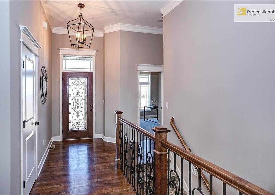 Entry way with view to 2nd bedroom (office) and hall closet. Open staircase goes down to walkout finished lower level. (Photo is of a previous model. Current home under construction)