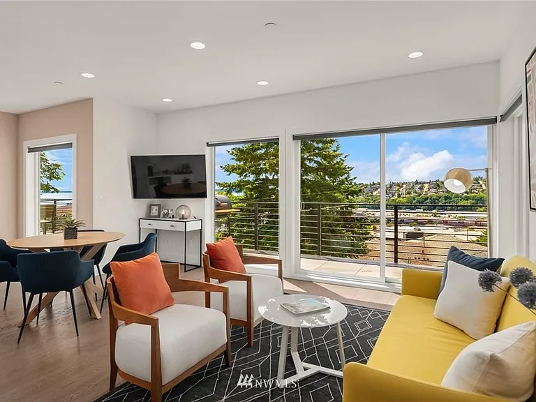 The living and dining area with wall of windows