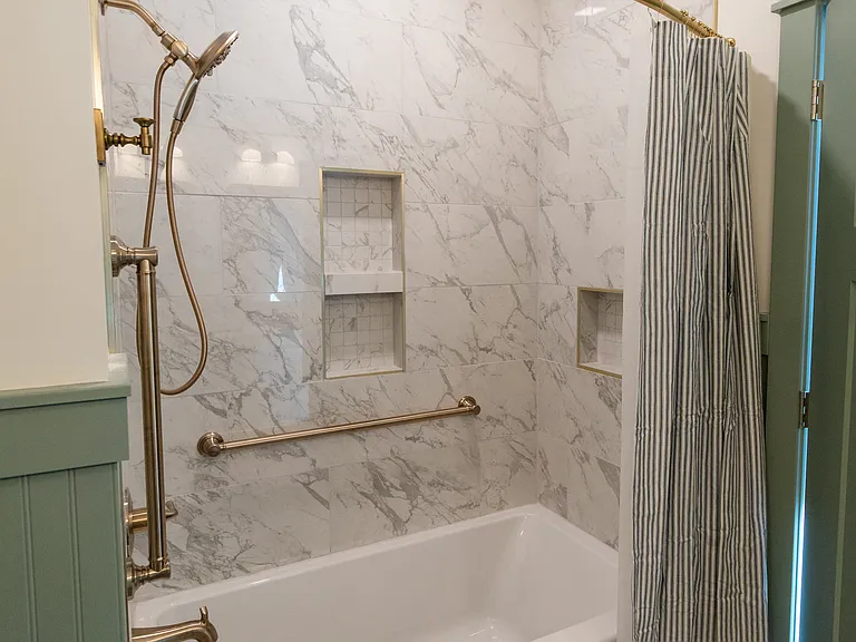 The full bathroom is located on the second floor between the two bedrooms and includes a double vanity, a shower/tub, and a toilet with a pocket door for privacy.