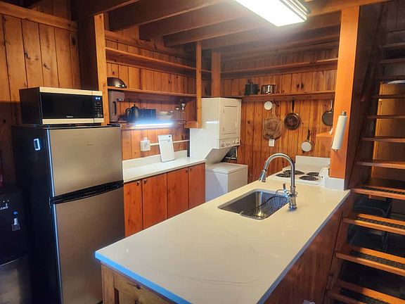 Fully equipped kitchen, with fridge, microwave, range with oven, coffee maker, tea kettle, pots and pans, silverware, and other kitchen necessities. Spices and basic condiments, too! Washer/dryer in kitchen