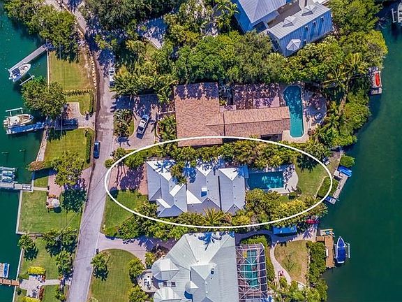 The aerial shows the two sides of waterfront - both navigable by boat with no fixed bridges to Sarasota Bay or the Gulf of Mexic
