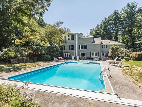Mature plantings and beautiful gardens surround heated-in ground pool.