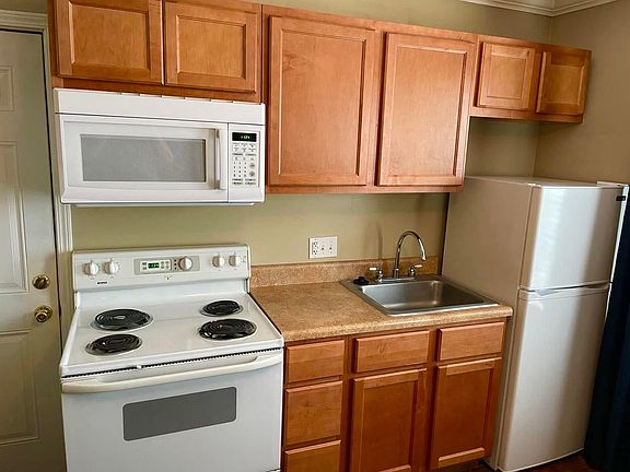 Kitchen with full size stove and microwave.