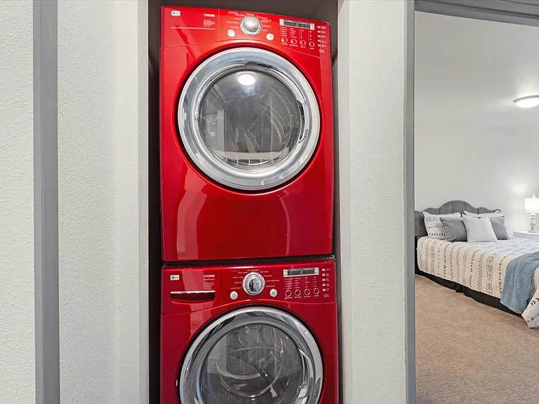Full sized and stacked washer and dryer.