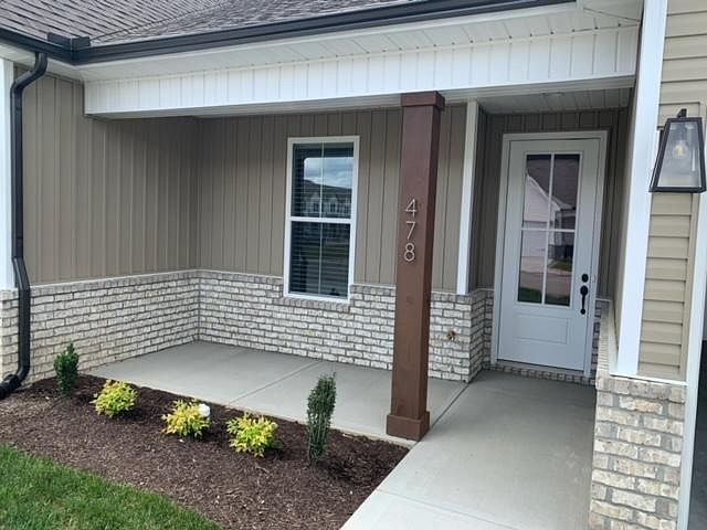 Front entrance. Driveway spaces as well as attached garage.