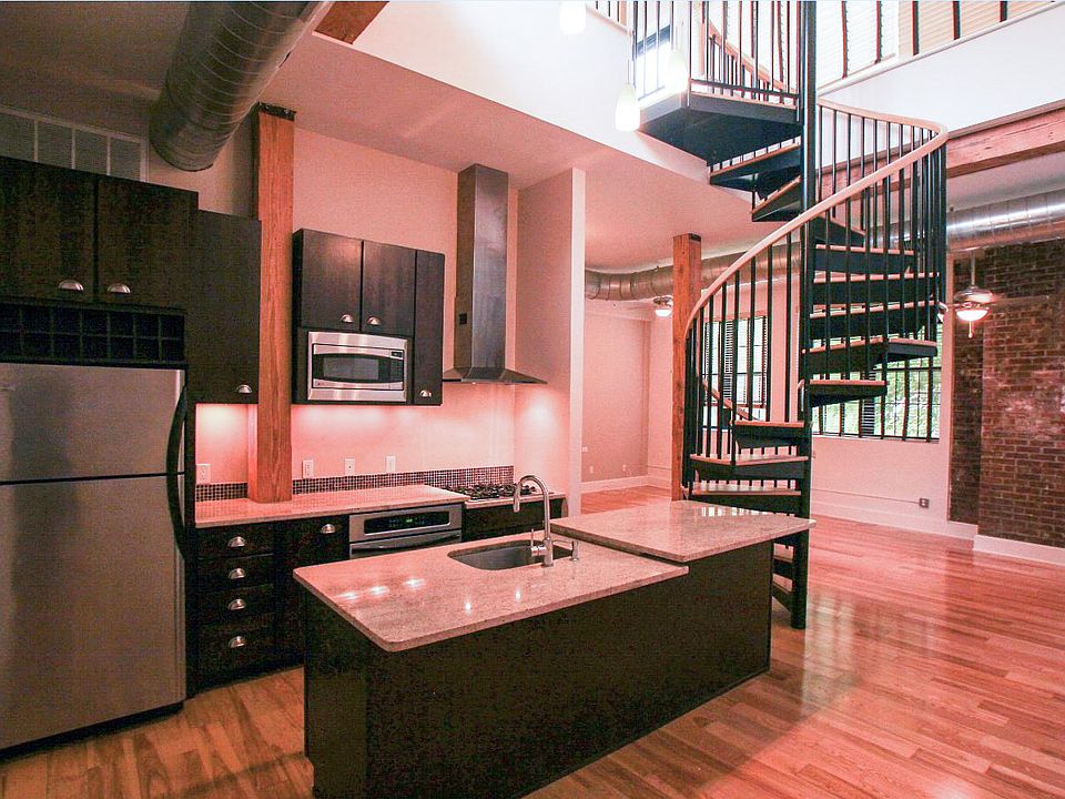Kitchen w/ granite countertops, SS appliances, and solid walnut cabinets. Spiral staircase to "sleeping loft" with access to rooftop deck.