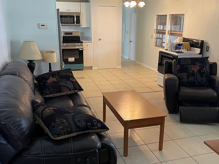 open living room, eat in kitchen with tile flooring throughout entire unit.