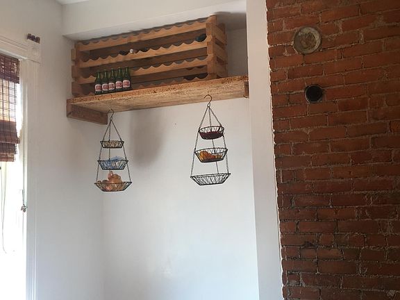 kitchen has dining nook with wine rack above