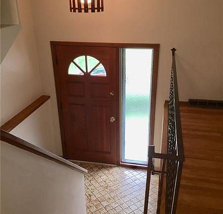 Ceramic entry with polished hardwood door, trim and staircase!