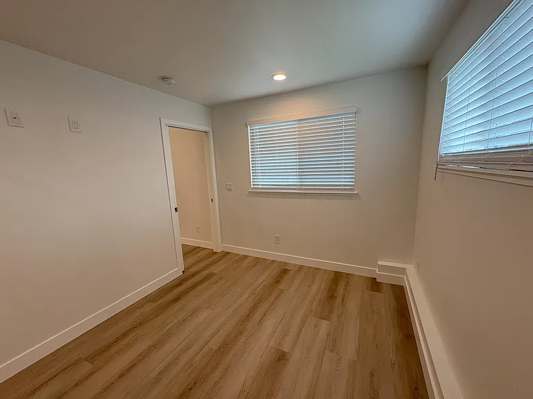 Bedroom with south-facing window that views the driveway.