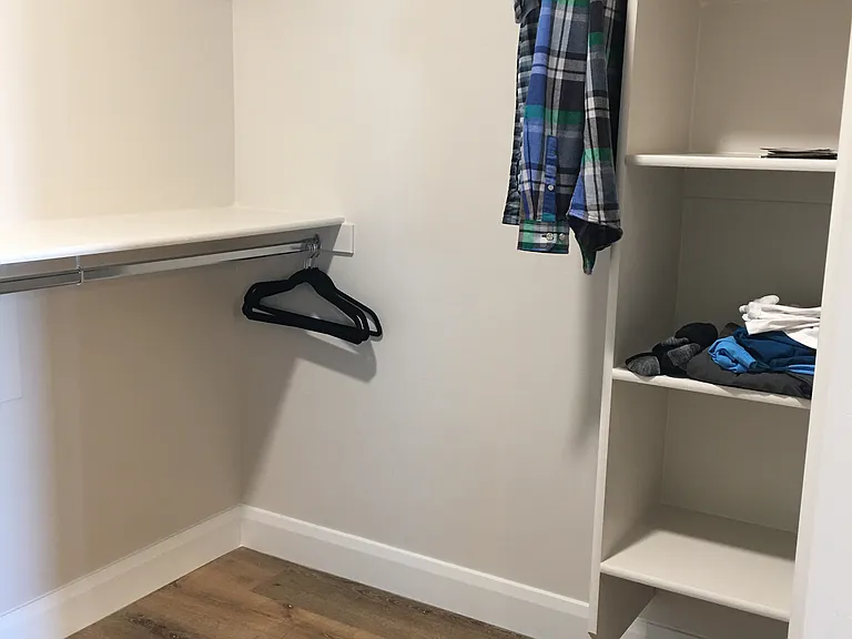 Partial view of master bedroom walk-in closet (shows half of shelving and closet space)