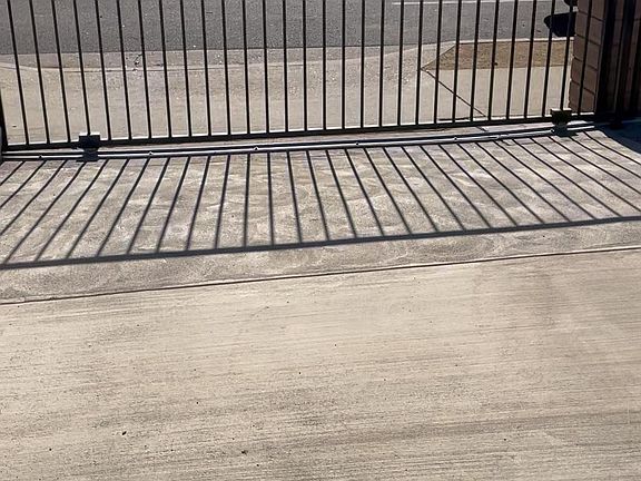 Sliding gate locking to driveway