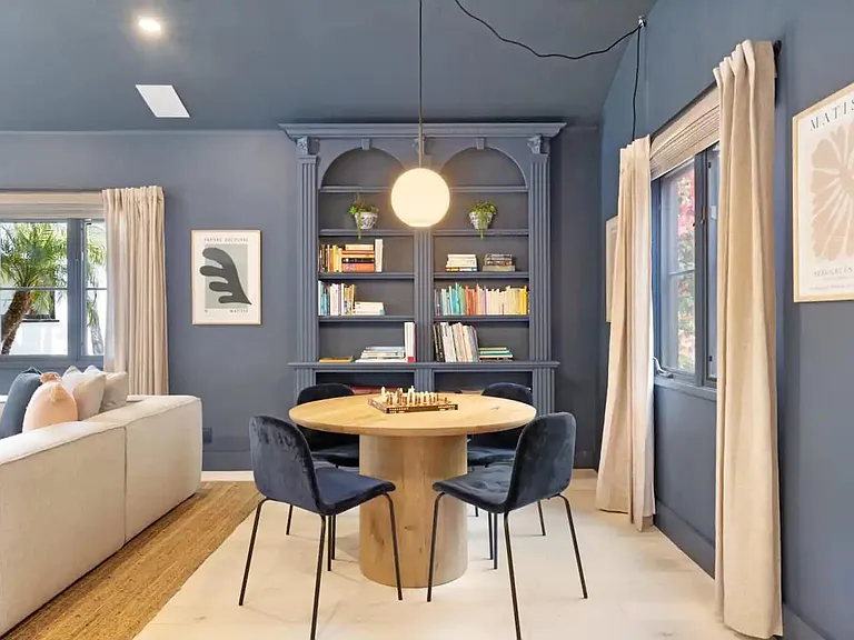Cozy walls lined with books and art.