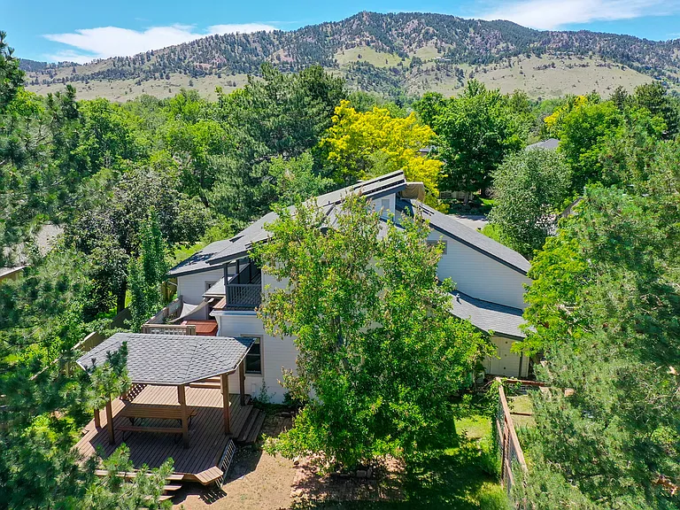 A bird's-eye view highlights one of the home's greatest assets: a spacious, beautifully landscaped lot offering privacy, character, and room to enjoy Colorado's outdoor lifestyle.