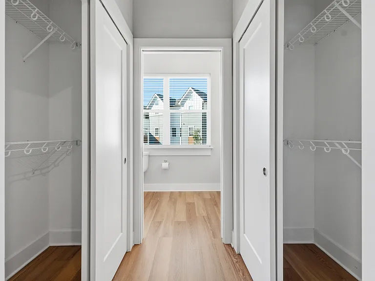 primary closets and view to primary bathroom
