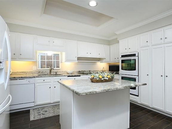 Spacious kitchen with recently painted cabinets and 2022 cooktop.