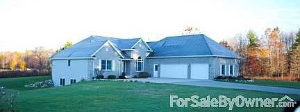 Front of the house
						:
						View from the private drive. Sprinkler system, sandy beach and surrounding pond.
