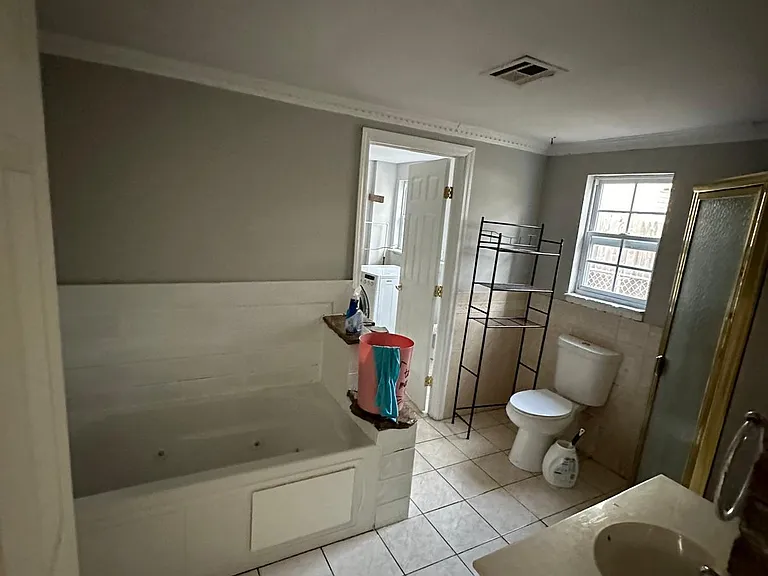 first main bathroom has a tub and a closed in shower on the side