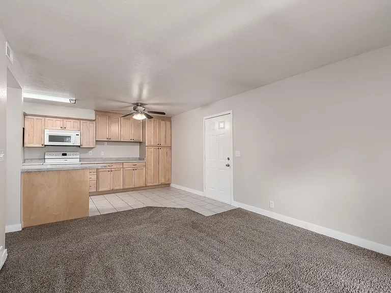 View of living room, kitchen and dining nook from the balcony door.