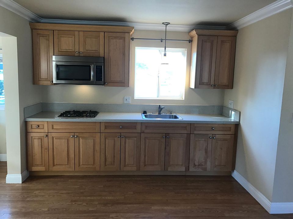 Galley kitchen is bright. Lots of dual pane windows